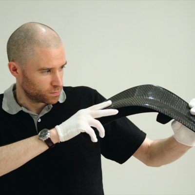 CEO James Murphy holding carbon fiber part made at HLH