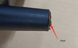 Flash or spew defect in injection molding